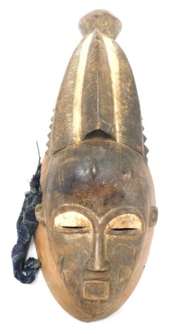 A Baule/Baoule Rare 'Diviners' Mblo portrait mask with open mouth, Cote D'Ivoire, approximately 60 years old, 46cm high.