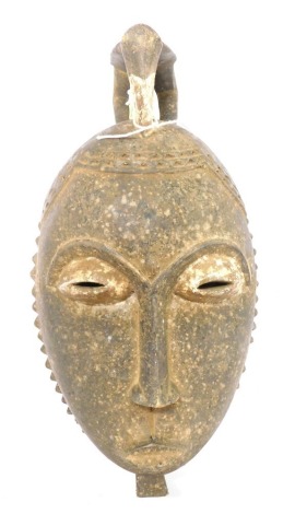 A Baule/Baoule Old Mblo portrait mask with encrusted patina and peace bird, Cote D'Ivoire, approximately 60 years old, 37cm high.