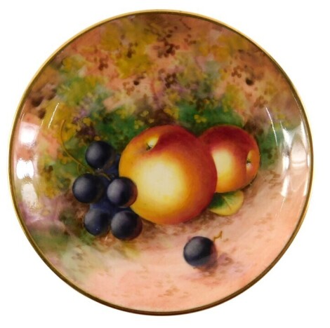 A Royal Worcester porcelain pin tray, decorated with fruit, signed Roberts, 9cm diameter.