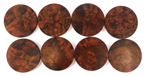 A set of eight Linley figured burr walnut glass coasters, 10cm diameter.