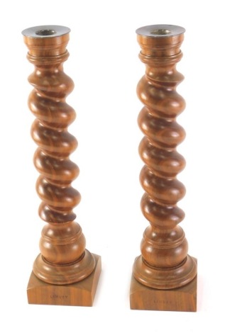 A pair of Linley turned walnut candlesticks, each with a silver plated sconce, 39.5cm high.