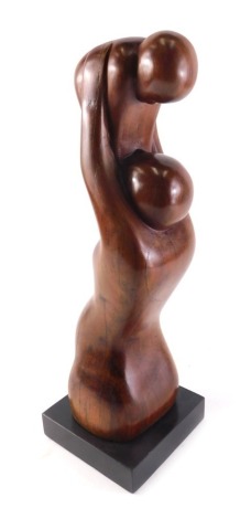 A mahogany sculpture of a mother and child, by Jennifer Watt of North Kelsey Moor Lincolnshire, on a black slate base, 43cm high.