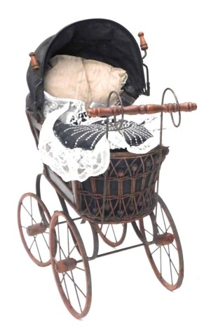 A Victorian style doll's pram.