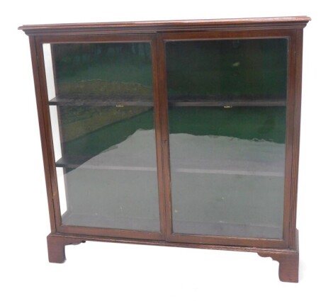 A late Victorian mahogany bookcase, with two glazed doors, on bracket feet, 135cm high, 140cm wide, 33cm deep.