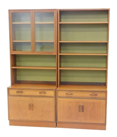 A two part G Plan teak wall unit, with shelved and glazed upper parts, single drawer over two door bases, on plinth, 200cm high, each 84cm wide, 44cm deep.