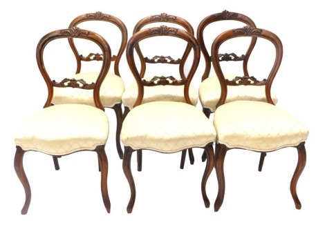 A set of six Victorian walnut balloon back dining chairs, with cabriole legs.