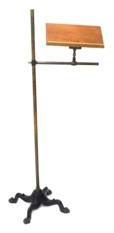 A Victorian adjustable brass music stand, with cast iron base.