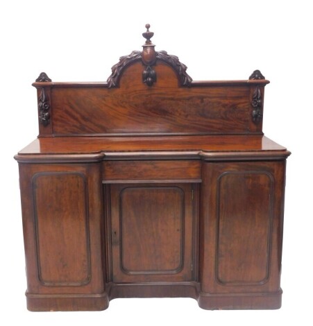 A Victorian mahogany inverted breakfront sideboard, with vine carved back, three panelled base with plinth, 95cm serving height, 157cm wide, 63cm deep.