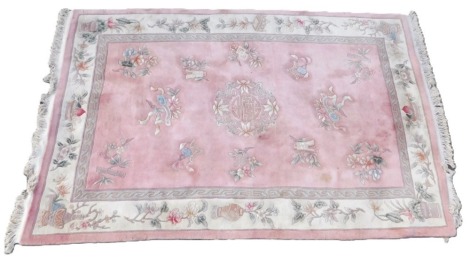 A Chinese pink ground all wool carpet, 278 x 183cm.