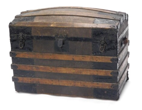 An early 20thC iron and wooden bound domed top trunk, 88cm wide.