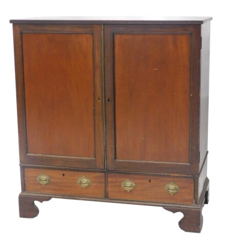 A 19thC mahogany press cupboard, with two doors revealing two sliding drawers over two further drawers and bracket feet, 115cm high, 107cm wide, 54cm deep.