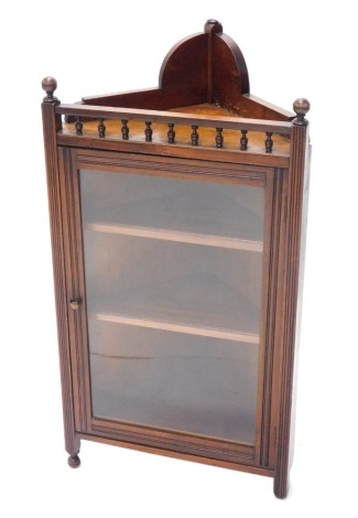 A late 19thC walnut hanging corner cabinet, with single glazed door, 106cm high, 56cm wide.