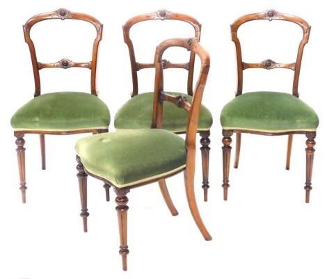 A set of four Victorian walnut aesthetic design balloon back dining chairs, with serpentine seats and fluted legs.