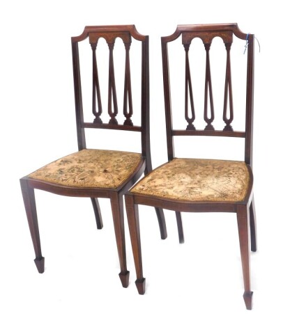 A pair of Edwardian marquetry bedroom chairs, on square taper legs.