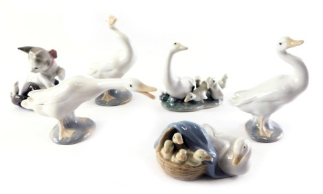 A group of Lladro porcelain figures, comprising a pair of geese, 10cm high, further birds, and a kitten with mouse seated on tail, 8cm high.