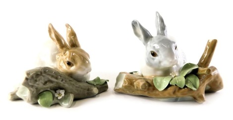 Two Lladro porcelain figures modelled as rabbits beside flowering tree branch, printed marks, 10cm high.