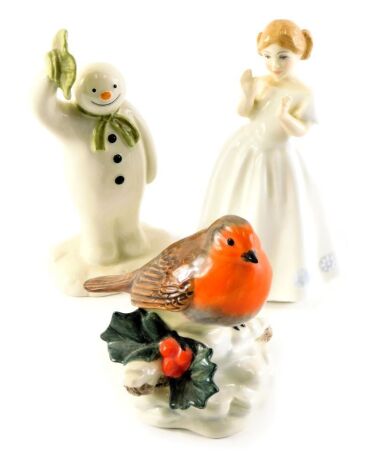 Three porcelain figures, comprising Royal Doulton Catherine, HN3044, a Beswick The Snowman figure, 14cm high, and a Beswick porcelain figure modelled as a robin beside holly, 10cm high. (3)