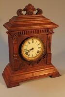 An American Ansonia Clock Company oak mantel clock with enamel dial