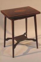 An Edwardian folding games table with replacement leather insert