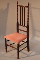 An Arts and Crafts style spindle and slat back nursing chair.