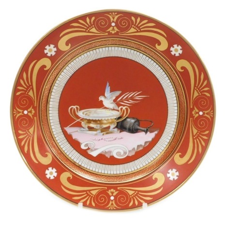 A mid 19thC Sevres Etruscan red ground hard paste porcelain dessert plate, decorated with a dove, flagon, beads and a twin handled cup, within a stylised gilt anthemion leaf and scroll border, Napoleon crowned 'N' mark in iron red, 24cm diameter. Auctione