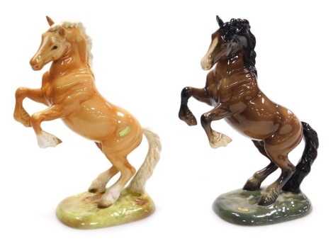 Two Beswick pottery figures of rearing horses, model number 1015, one Palomino, the other brown gloss, raised on naturalistic bases, impressed and printed marks.