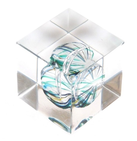 An Orrefors glass cube paperweight, with an abstract sea urchin type inclusion, etched mark, 4cm wide.