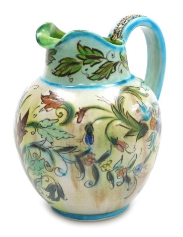 A Denby pottery jug, designed by Glyn Colledge, decorated with flowers and scrolling leaves, within turquoise borders, printed marks and painted signature, 32cm high.