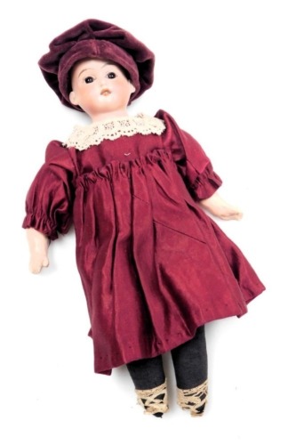 An Armand Marseilles bisque head doll, A.M.-12/0, with a fabric body, wearing a Tudor style dress, 24cm high.