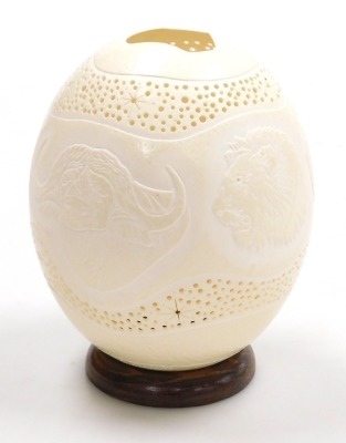 An ostrich egg night light, carved with wild animals, within pierced star and dot borders, on a turned wooden base, 18cm high. - 3