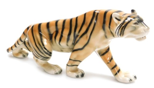 A Royal Dux porcelain figure of a tiger, number 32/1 55, impressed and printed marks, 38cm wide.