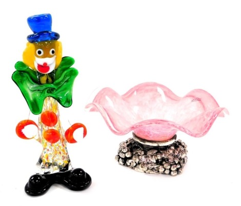 A late 20thC Murano glass figure of a clown, 24cm high, together with a Dettagli pink and white wavy glass bowl, on a silvered metal base, cast with vines, bears label, 22cm diameter.(2)