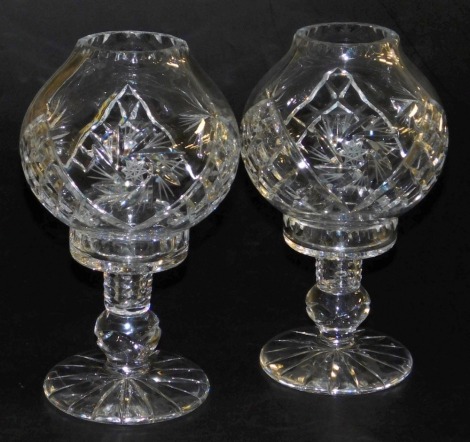 A pair of late 20thC cut glass storm lamp type candle holders, 26cm high.