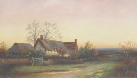 British School (Early 20thC). Thatched farmstead in a country landscape, oil on canvas, monogrammed, dated 1908, 26cm x 43cm.