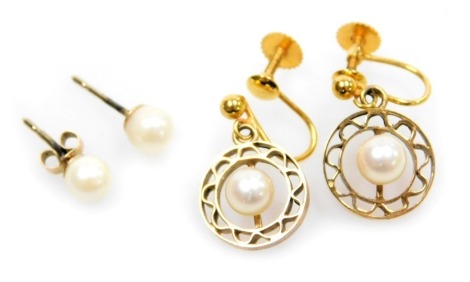 A pair of 9ct gold and and single cultured pearl earrings, and a further pair of cultured pearl earrings, in a circular pierced dropped setting, on screw fittings, stamped 9ct, 3.0g.