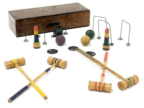 An early 20thC vintage table croquet set, with four mallets and balls, five hoops and two markers, oak boxed.