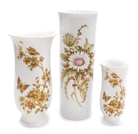 A Kaiser porcelain Silberdistel vase, of cylindrical form, decorated with flowers 30.5cm high, a vase decorated in the Madeleine pattern, designed by Nossek, 25cm high and a smaller vase 17.5cm high. (3)