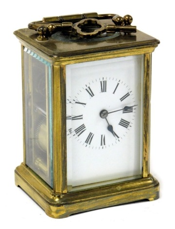 A brass carriage clock, rectangular enamel dial bearing Roman numerals, single barrel movement, the case of conventional form, with key, 11cm high.