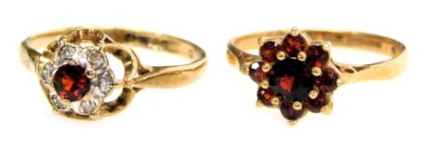 Two 9ct gold flowerhead cluster rings, one set with garnets, the other with a small ruby within a border of tiny white stones, 3.50g all in.