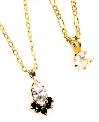 A 9ct gold pendant drop, set with a marquise shaped synthetic diamond and fine tiny sapphires, with thin chain necklet, and another 9ct gold chain necklet with synthetic solitaire pendant. (2)