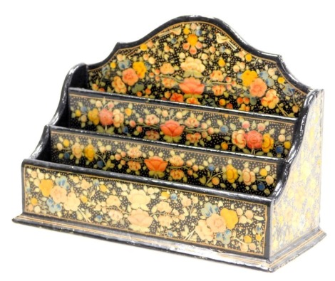 An early 20thC Indian Kashmiri papier mache letter rack, of three tier graduated form, decorated with flowers, 21.5cm wide.