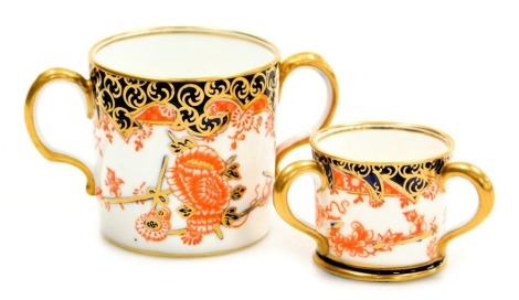 A Royal Crown Derby porcelain loving cup, circa 1915, Imari decorated with flowers, pattern 2649, together with a miniature tyg, also 1915, printed marks. (2)