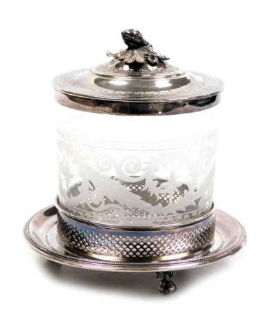 A late 19thC cut glass biscuit barrel, with plated mount and hinged lid, with engraved decoration, on a circular galleried stand, above three ball and claw feet, 21cm high.