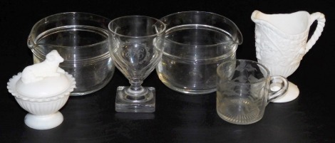 A pair of Regency cut glass wine rinsers, cut glass rummer with etched monogram, Sowerby moulded glass mug etched with ferns, white pressed glass cream jug and a milk glass mint sauce pot and cover, moulded to the lid with a ram. (6)