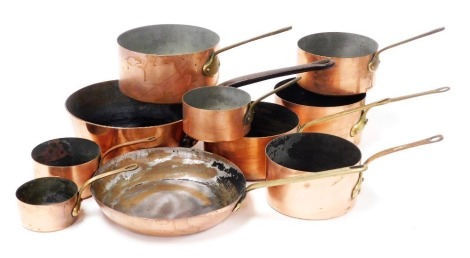 A group of vintage copper saucepans, and frying pans, with brass or cast iron handles. (10)