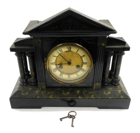 A late 19thC ebonised faux marble mantle clock, circular brass dial with chapter ring bearing Roman numerals, eight day movement with coil strike, the case of architectural form, with pendulum and key, 42.5cm wide.