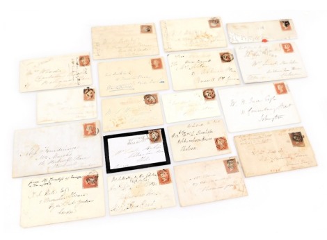 Philately. Nineteen Queen Victoria unperforated penny red stamp envelopes, all addressed, some with wax seals or crests.