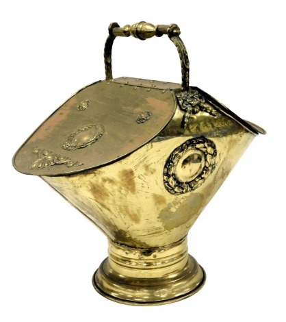 A Victorian brass neo classical style double coal scuttle, with embossed wreath and foliate motifs, 58cm high.