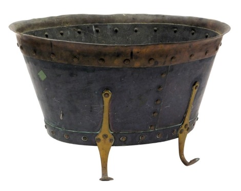 A Victorian copper and brass bound coal bucket, with studded detailing, raised on four scroll legs, 48cm wide.