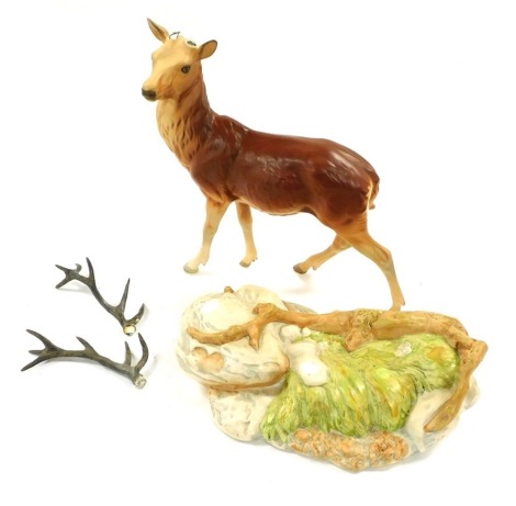 A Beswick Royal Doulton pottery figure of a deer stag, raised on a naturalistic base, matt glazed, printed marks. (AF)